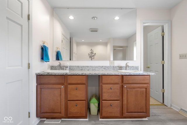 3905 Cove Rd, Columbus, IN 47203 - bathroom featuring double vanity, wood finished floors, recessed lighting, and a shower