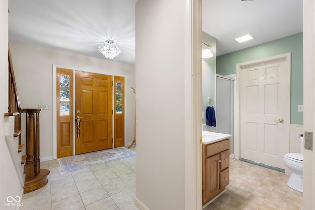3905 Cove Rd, Columbus, IN 47203 - entryway with stairway, a chandelier, and light tile patterned floors