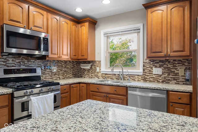 3905 Cove Rd, Columbus, IN 47203 - kitchen with stainless steel appliances, light stone countertops, brown cabinetry, and recessed lighting