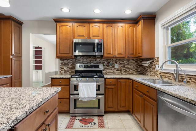 3905 Cove Rd, Columbus, IN 47203 - kitchen featuring stainless steel appliances, light stone counters, tasteful backsplash, light tile patterned flooring, and recessed lighting