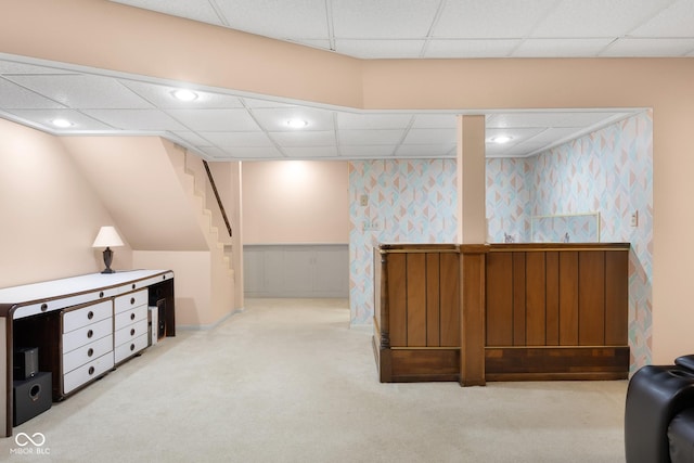 3905 Cove Rd, Columbus, IN 47203 - finished basement with carpet floors, a drop ceiling, stairs, wainscoting, and wallpapered walls