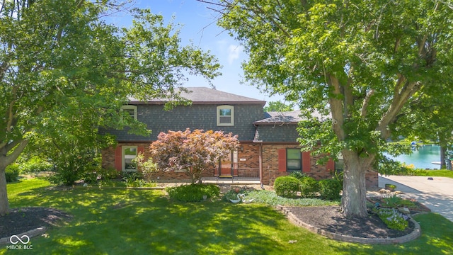 3905 Cove Rd, Columbus, IN 47203 - view of front of home featuring brick siding, a front lawn, and a shingled roof