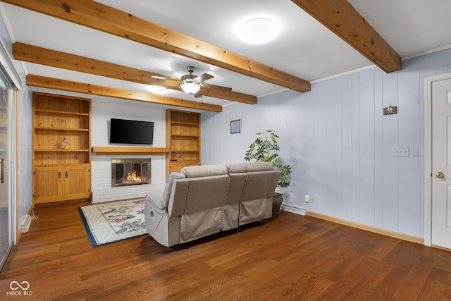 3905 Cove Rd, Columbus, IN 47203 - living area featuring beamed ceiling, wood finished floors, a fireplace, and ceiling fan