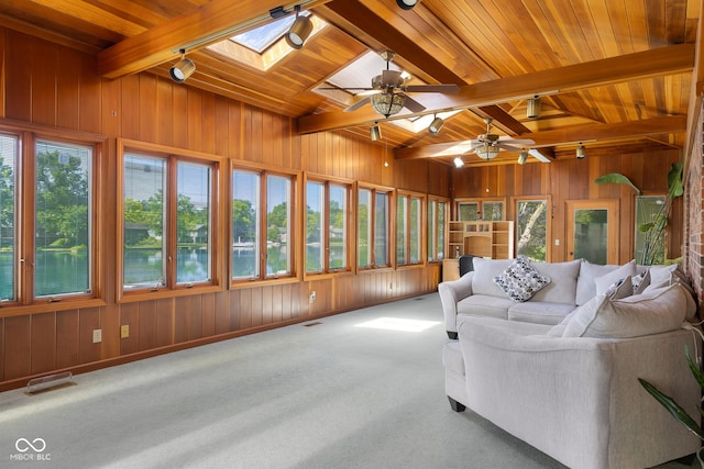 3905 Cove Rd, Columbus, IN 47203 - sunroom featuring a skylight, wooden walls, a wooden ceiling with exposed beams, carpet flooring, and track lighting
