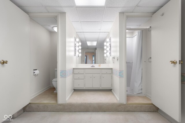 3905 Cove Rd, Columbus, IN 47203 - full bathroom with vanity, a shower stall, a drop ceiling, and tile patterned flooring