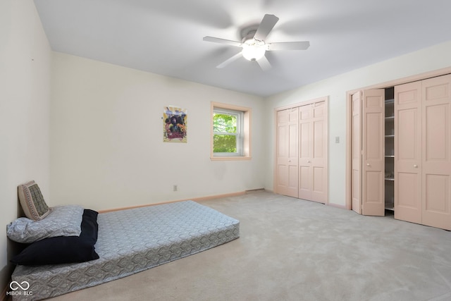 3905 Cove Rd, Columbus, IN 47203 - carpeted bedroom featuring multiple closets and ceiling fan
