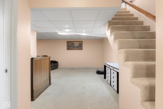 3905 Cove Rd, Columbus, IN 47203 - basement featuring carpet flooring, a paneled ceiling, and stairway