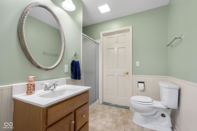 3905 Cove Rd, Columbus, IN 47203 - bathroom with wainscoting, vanity, and a shower stall