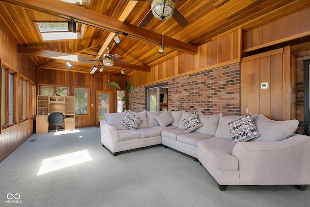3905 Cove Rd, Columbus, IN 47203 - living area with ceiling fan, wood walls, carpet, wood ceiling, and a skylight