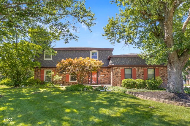 3905 Cove Rd, Columbus, IN 47203 - view of front of home featuring mansard roof, a front lawn, brick siding, and roof with shingles