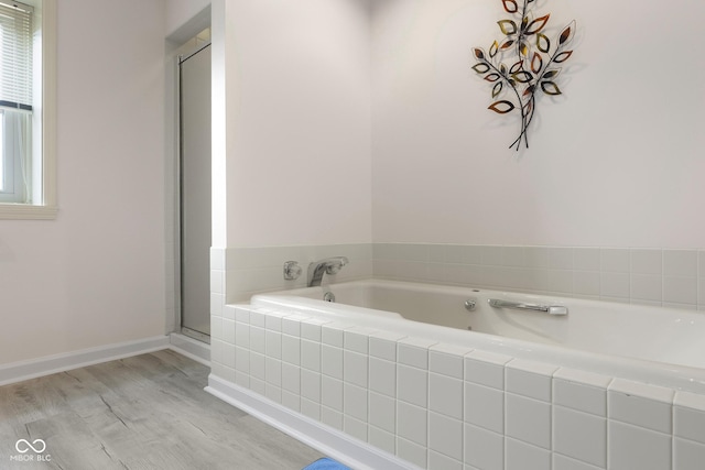 3905 Cove Rd, Columbus, IN 47203 - bathroom with a garden tub, healthy amount of natural light, wood finished floors, and an enclosed shower