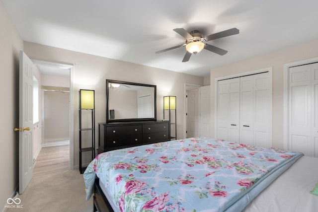 3905 Cove Rd, Columbus, IN 47203 - bedroom featuring light colored carpet, two closets, and ceiling fan