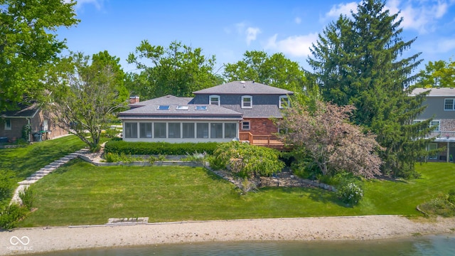 3905 Cove Rd, Columbus, IN 47203 - rear view of house with a sunroom, a deck with water view, a lawn, and a chimney