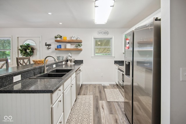 897 Wildwood Rd, North Vernon, IN 47265 - kitchen featuring stainless steel appliances, light wood-style floors, open shelves, a peninsula, and white cabinets