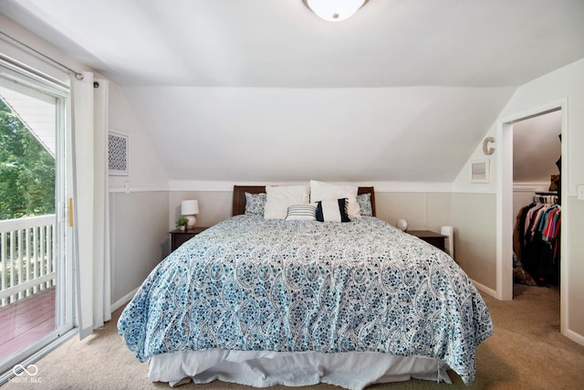 897 Wildwood Rd, North Vernon, IN 47265 - bedroom with lofted ceiling, carpet, access to outside, and a walk in closet