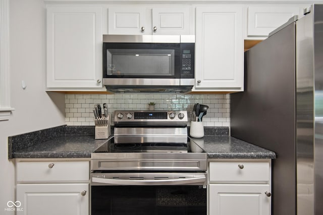 897 Wildwood Rd, North Vernon, IN 47265 - kitchen with appliances with stainless steel finishes, dark countertops, tasteful backsplash, and white cabinets