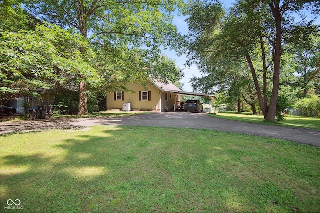897 Wildwood Rd, North Vernon, IN 47265 - view of front of home featuring asphalt driveway, a front yard, and a carport