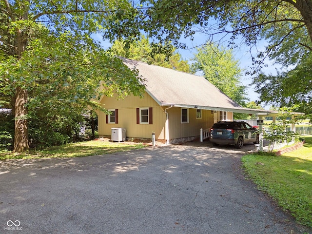 897 Wildwood Rd, North Vernon, IN 47265 - view of home's exterior featuring asphalt driveway and a shingled roof