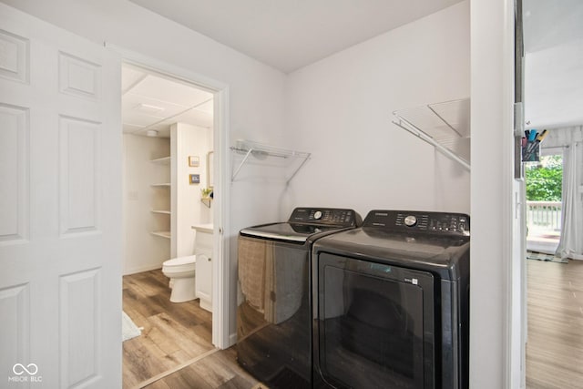 897 Wildwood Rd, North Vernon, IN 47265 - washroom with washing machine and clothes dryer and wood finished floors