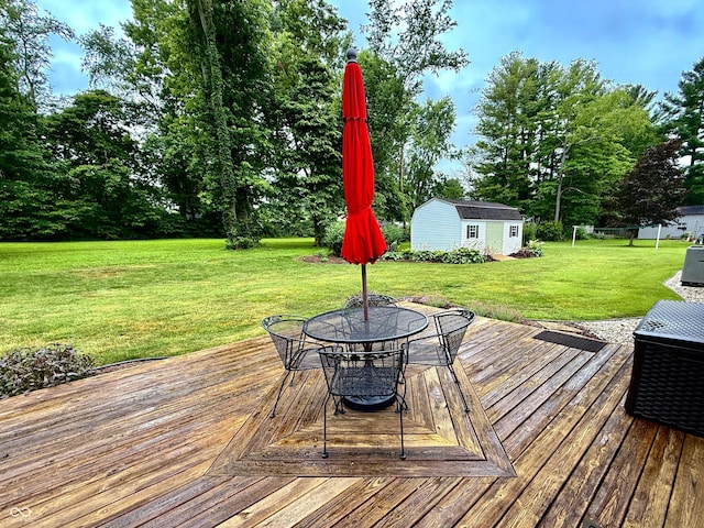 56 E Colony Acres Dr, Brazil, IN 47834 - wooden terrace featuring outdoor dining area, a lawn, an outdoor structure, and view of scattered trees