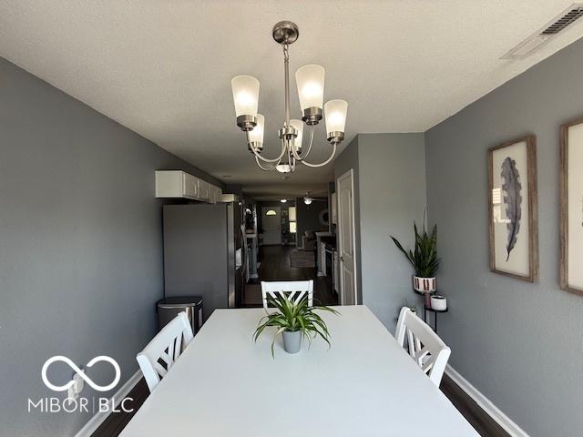 5714 High Timber Ln, Indianapolis, IN 46235 - dining space featuring baseboards and a chandelier