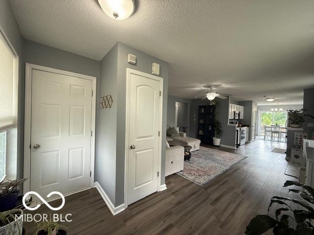 5714 High Timber Ln, Indianapolis, IN 46235 - living area with dark wood finished floors, ceiling fan, and a textured ceiling