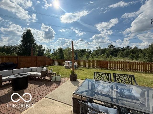 5714 High Timber Ln, Indianapolis, IN 46235 - fenced backyard with a patio, outdoor dining area, an outdoor living space with a fire pit, and grilling area