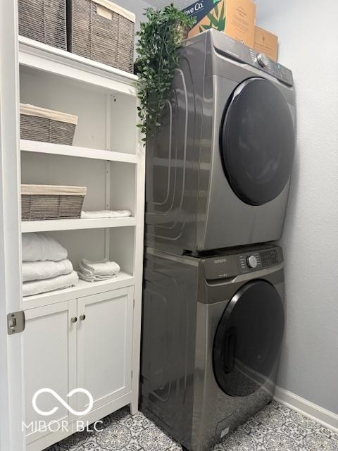 5714 High Timber Ln, Indianapolis, IN 46235 - laundry area featuring stacked washer and clothes dryer and cabinet space
