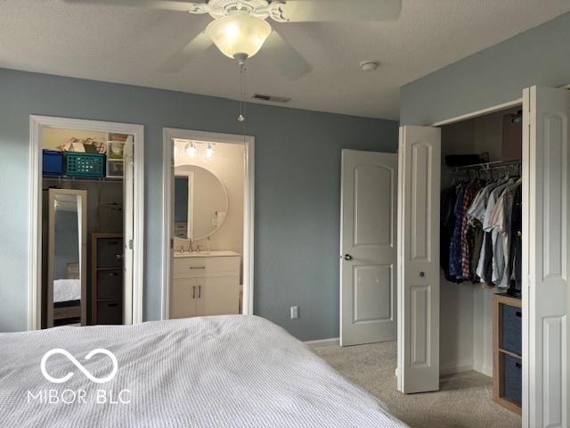 5714 High Timber Ln, Indianapolis, IN 46235 - carpeted bedroom with ensuite bath, a spacious closet, and ceiling fan