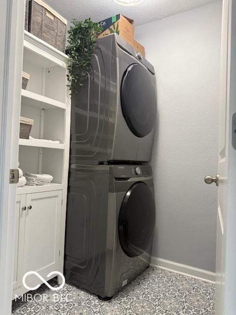 5714 High Timber Ln, Indianapolis, IN 46235 - washroom with stacked washer and clothes dryer and a textured ceiling
