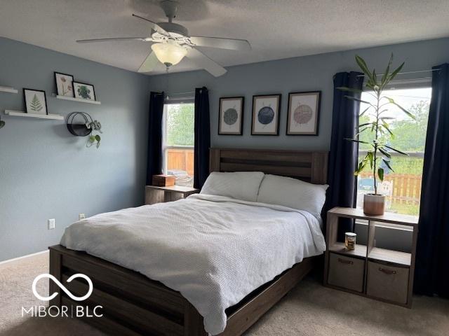 5714 High Timber Ln, Indianapolis, IN 46235 - bedroom with light carpet and ceiling fan