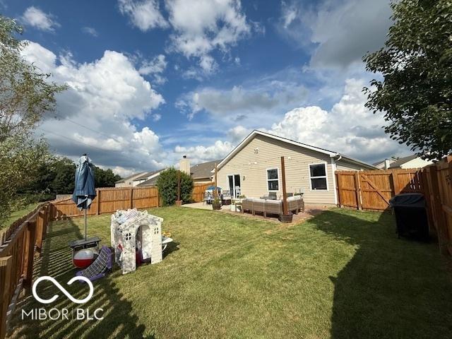 5714 High Timber Ln, Indianapolis, IN 46235 - back of house featuring an outdoor living space and a fenced backyard