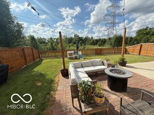 5714 High Timber Ln, Indianapolis, IN 46235 - fenced backyard with a patio area and an outdoor living space with a fire pit