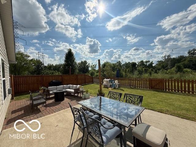 5714 High Timber Ln, Indianapolis, IN 46235 - fenced backyard with an outdoor living space with a fire pit, a patio area, and outdoor dining space