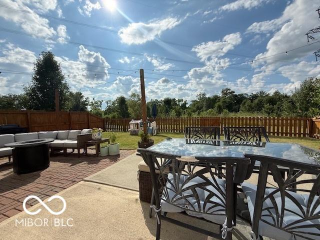 5714 High Timber Ln, Indianapolis, IN 46235 - fenced backyard featuring outdoor dining area, a patio, and an outdoor living space with a fire pit