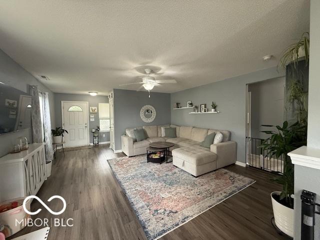 5714 High Timber Ln, Indianapolis, IN 46235 - living room featuring a ceiling fan, dark wood-style flooring, and a textured ceiling