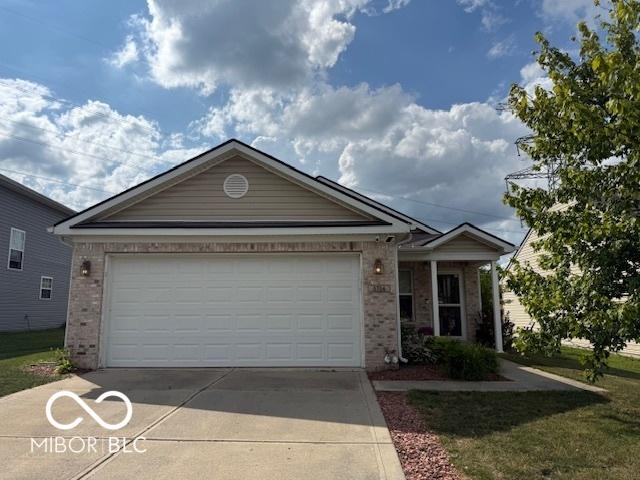 5714 High Timber Ln, Indianapolis, IN 46235 - single story home featuring brick siding, driveway, and an attached garage