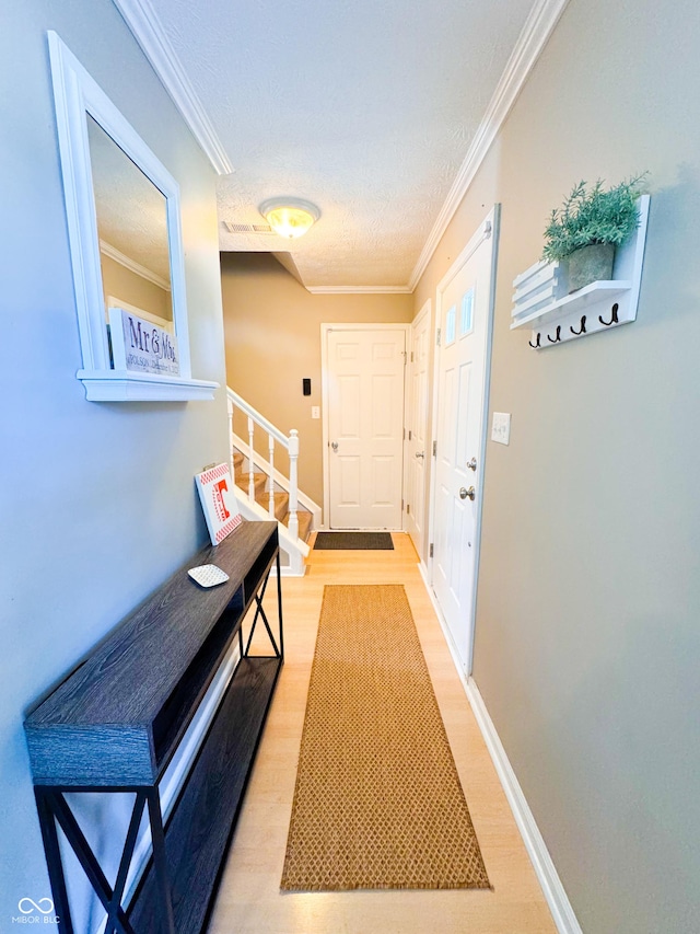 8017 Cardinal Cv W, Indianapolis, IN 46256 - entryway featuring crown molding, light wood-style floors, and stairway