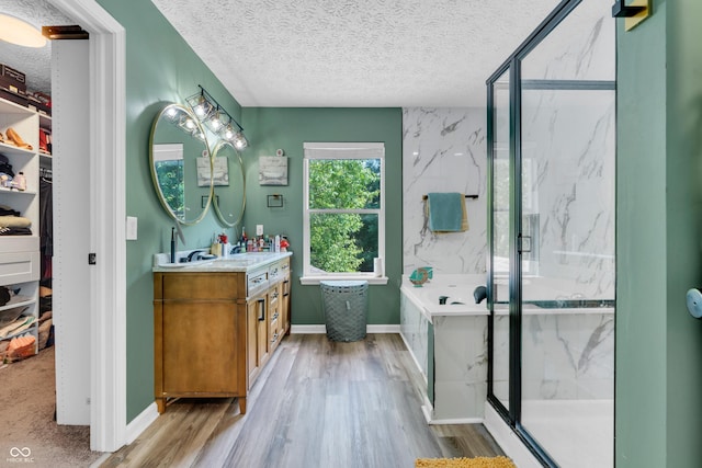 10249 Winlee Ct, Indianapolis, IN 46236 - full bathroom featuring vanity, a marble finish shower, a textured ceiling, wood finished floors, and a garden tub