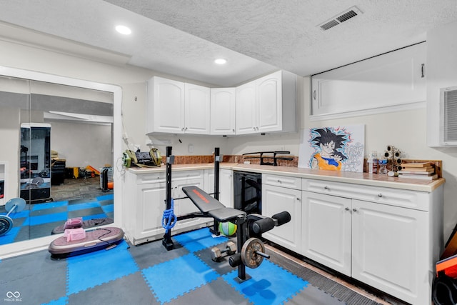 10249 Winlee Ct, Indianapolis, IN 46236 - exercise room with a textured ceiling, recessed lighting, and beverage cooler