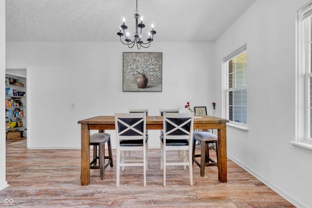 10249 Winlee Ct, Indianapolis, IN 46236 - dining room with a chandelier, wood finished floors, and a textured ceiling