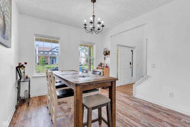10249 Winlee Ct, Indianapolis, IN 46236 - dining area with a chandelier, wood finished floors, and a textured ceiling