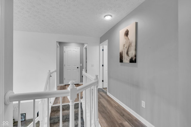10249 Winlee Ct, Indianapolis, IN 46236 - hall featuring an upstairs landing, wood finished floors, and a textured ceiling