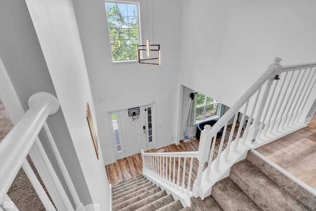 10249 Winlee Ct, Indianapolis, IN 46236 - foyer featuring healthy amount of natural light, a high ceiling, stairway, and wood finished floors