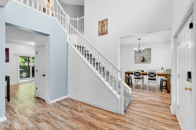 10249 Winlee Ct, Indianapolis, IN 46236 - foyer entrance with wood finished floors, stairway, a towering ceiling, and a chandelier