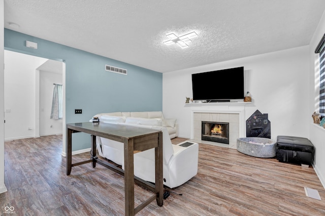 10249 Winlee Ct, Indianapolis, IN 46236 - living room with a textured ceiling, wood finished floors, and a fireplace