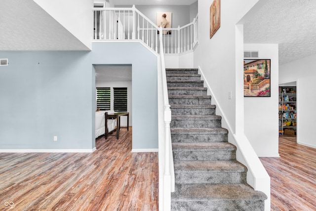 10249 Winlee Ct, Indianapolis, IN 46236 - stairs with wood finished floors and a textured ceiling