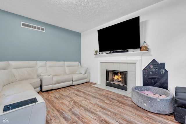 10249 Winlee Ct, Indianapolis, IN 46236 - living area featuring wood finished floors, a textured ceiling, and a fireplace