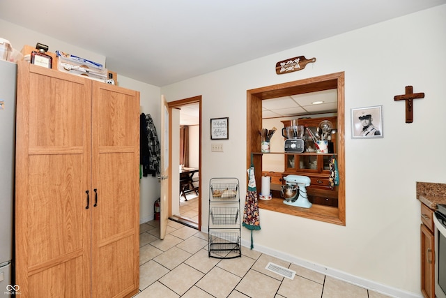 4020 S Lynhurst Dr, Indianapolis, IN 46221 - hallway featuring light tile patterned floors and baseboards