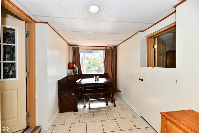 4020 S Lynhurst Dr, Indianapolis, IN 46221 - dining room with light tile patterned flooring, a paneled ceiling, and ornamental molding